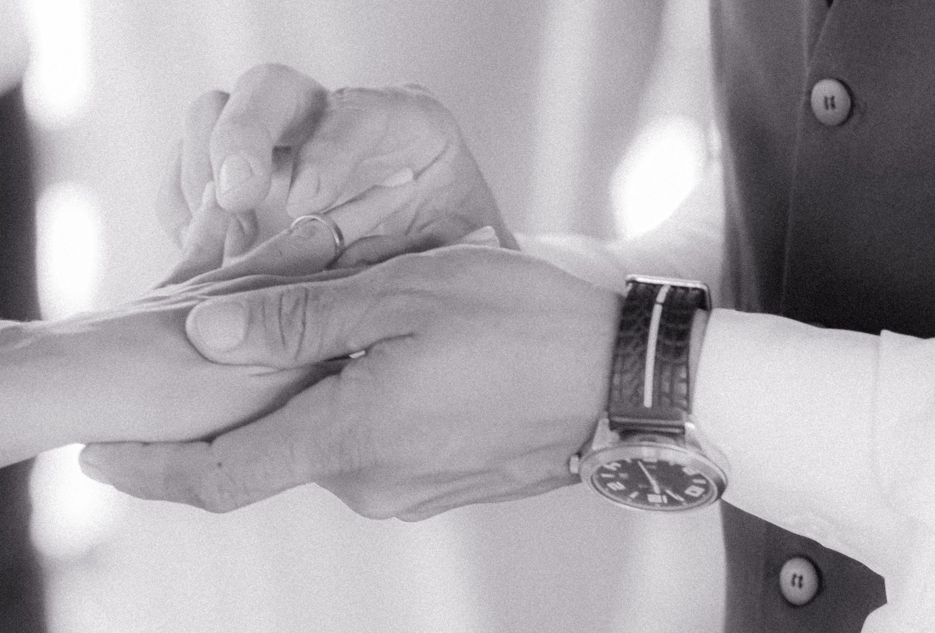 romantic wedding ring exchange moment in black and white
